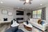 Elegant living room with modern fireplace, plush sofa, and stylish decor, perfect for relaxation and entertaining.
