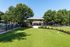 Inviting outdoor space with lush green lawn, shaded pavilion, and relaxing pool area perfect for gatherings.