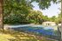 Lush outdoor area featuring tennis and soccer courts set against a backdrop of vibrant greenery, perfect for recreation and relaxation.