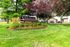Beautifully landscaped entrance to Veridian of Lexington Apartments, featuring vibrant greenery and a welcoming atmosphere.