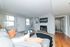 Inviting living room in British Woods apartment featuring a cozy fireplace, modern decor, and a comfortable gray sofa with accent pillows.
