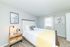 Bright and cozy bedroom with elegant decor, featuring a comfy bed, stylish nightstand, and inspiring wall art.
