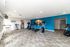Bright, modern gym featuring treadmills and exercise bikes against a vibrant blue accent wall with motivational decor.