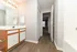Elegant bathroom with chic vanity, warm lighting, and stylish wood flooring.