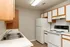 Cozy kitchen with modern appliances, dual sink, and ample cabinet space, perfect for culinary enthusiasts.