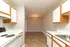 Inviting kitchen and dining space featuring modern cabinetry, sleek countertops, and ambient chandelier lighting.