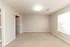 Bright and spacious bedroom with plush carpet and large window inviting natural light.