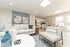 Charming open-concept living area with elegant decor, cozy seating, and a modern kitchen perfect for entertaining.