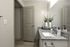 Modern bathroom featuring elegant granite countertop, sleek fixtures, and stylish decor with fresh towels.