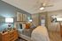 Elegant bedroom with plush bedding, modern decor, and serene lighting for a luxurious retreat.