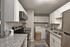 Modern kitchen with sleek granite countertops, stainless steel appliances, and in-unit laundry for convenient living.