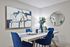Modern dining room with elegant blue chairs, abstract wall art, and a stylish table setting, perfect for entertaining.