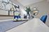 Elegant dining room setup with modern abstract art, stylish decor, and vibrant blue accents.