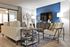 Modern living room with stylish furniture, elegant lighting, and a vibrant blue accent wall.
