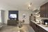Chic apartment interior featuring a cozy kitchen with modern appliances, a stylish dining area with plush seating, and a warm living space with a large TV and tasteful decor.
