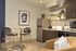 Cozy modern kitchen with sleek cabinetry, open shelving, and stylish dining nook for two.