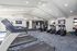 Bright and modern fitness center featuring state-of-the-art treadmills, elliptical machines, and vibrant decor.
