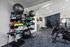 Contemporary fitness center with state-of-the-art exercise machines, vibrant workout equipment, and spacious interior.