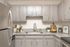 Chic modern kitchen with sleek gray cabinets, stainless steel appliances, and stylish granite countertops.