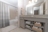 Chic bathroom with granite countertop vanity, ample storage, and elegant bathtub setup, perfect for relaxation.