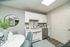 Charming kitchen with sleek white cabinetry, elegant decor, and modern stainless steel appliances, perfect for a cozy dining experience.