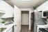 Bright and modern kitchen with sleek stainless steel appliances, white cabinetry, and elegant decor accents.