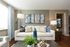 Bright and inviting living room with elegant decor, showcasing a cozy sofa adorned with patterned cushions, stylish abstract art, and abundant natural light.