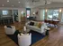 Spacious open-concept living and dining area with elegant decor, modern furniture, and expansive windows offering natural light.