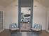 Chic modern lounge with stylish armchairs and abstract art, creating a serene and inviting atmosphere.