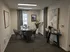 Cozy and modern meeting room with stylish seating, elegant decor, and refreshments, perfect for small gatherings.