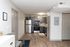 Modern kitchen with sleek gray cabinets, stainless steel appliances, and stylish wood flooring.