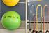 Vibrant home gym setup with colorful exercise balls and resistance bands, perfect for dynamic workouts.