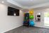 Modern fitness room with exercise balls, smart fitness equipment, and a large mirror, perfect for home workouts.