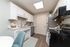 Bright, modern kitchen with sleek white cabinetry, stainless steel appliances, and hardwood floors, perfect for culinary creativity.