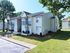 Charming two-story apartment with private balconies and lush green surroundings, offering a serene residential experience.
