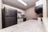 Modern kitchen with sleek stainless steel appliances, elegant white cabinetry, and polished granite countertops.