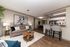 Modern open-concept living space featuring a cozy seating area, stylish breakfast bar, and elegant dining nook, perfect for comfortable living and entertaining.