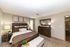 Chic bedroom with elegant decor featuring a plush bed, stylish wooden furniture, and contemporary artwork creating a cozy retreat.