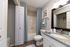 Elegant bathroom with modern fixtures, granite countertop, and soothing blue accents for a serene atmosphere.
