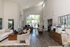Inviting and spacious community room with large windows, modern furniture, and warm decor. Perfect for social gatherings or quiet study sessions.