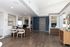 Modern office space with stylish decor, featuring hardwood floors, elegant furniture, and contemporary artwork on the walls.