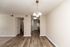 Bright apartment with elegant wood flooring, sophisticated chandelier, and a modern open-concept kitchen.