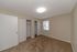 Bright and inviting bedroom with plush carpet, dual closets, and ample natural light from a large window.