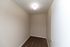 Cozy room featuring plush carpeting and serene neutral walls, illuminated by a soft ceiling light.