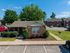 Charming brick apartment with manicured landscaping and ample parking, set in a peaceful suburban environment.