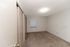Bright and spacious bedroom with textured ceiling, plush carpeting, and ample closet space.