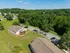 Charming aerial view of a peaceful apartment complex surrounded by lush greenery and vibrant neighborhood, perfect for serene living.