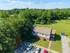 Charming two-story apartment nestled in lush greenery, featuring ample parking and tranquil surroundings.