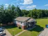 Charming duplex with spacious balcony nestled in a lush, green setting. Ample parking and surrounded by serene natural beauty.