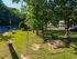 Charming green space with play area, swings, and mature trees, perfect for family enjoyment in a serene neighborhood.